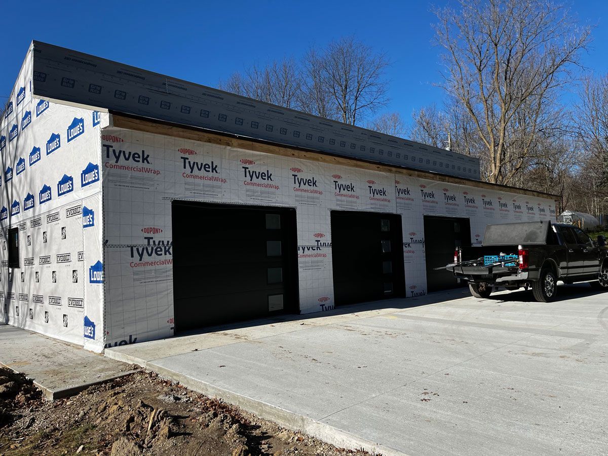 A building under construction with a truck parked in front of it.