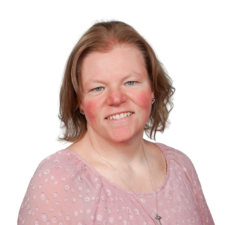 Smiling woman in a light pink top against a white background