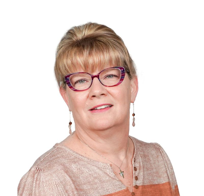 Portrait of a smiling person wearing red glasses and a light pink top on a white background