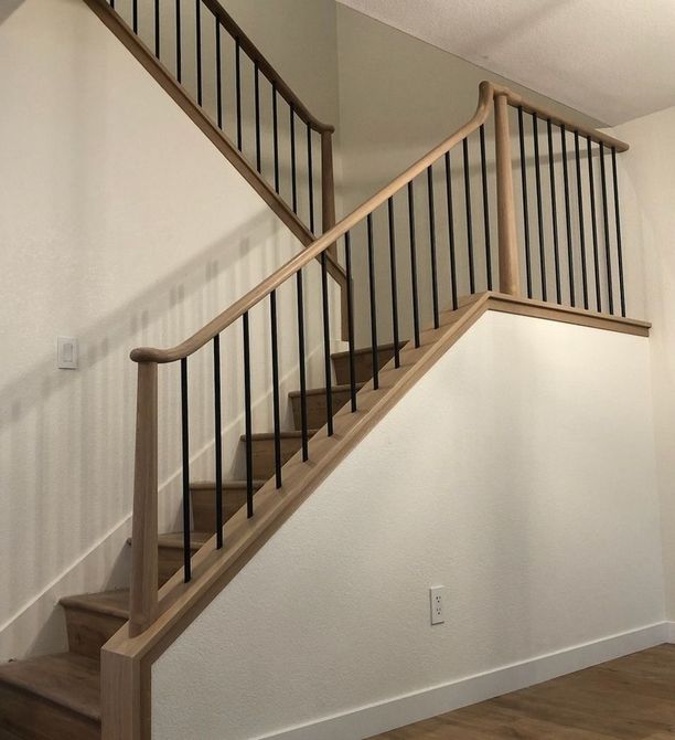 Modern Style Staircase Design with Round Tapered White Oak Wooden Posts and Oval Handrailing with Vertical Round Black Rod Balusters