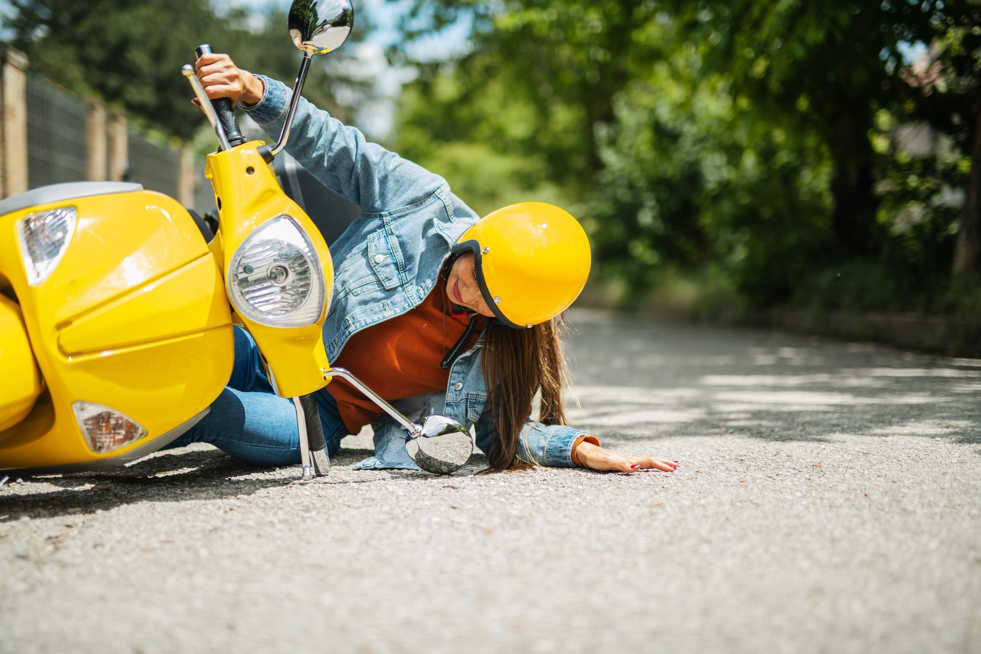 Picture of a woman having a motorcycle accident on the street. Picture of a woman having a motorcycle accident on the street.