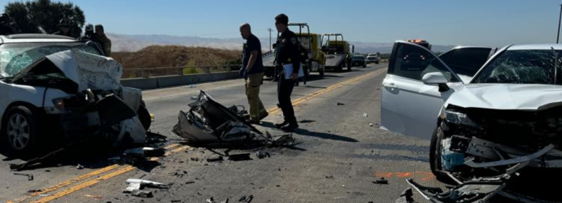 Two cars are damaged in a car accident on the side of the road. - Bank on Frank