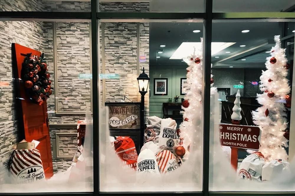 A Store Window Decorated for Christmas with A White Christmas Tree — City Glass Newcastle in Jewells, NSW
