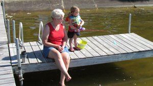 grandmother and child on dock