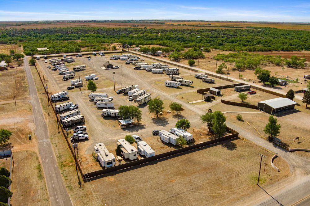 an aerial view of a rv park with a lot of rvs parked in it .