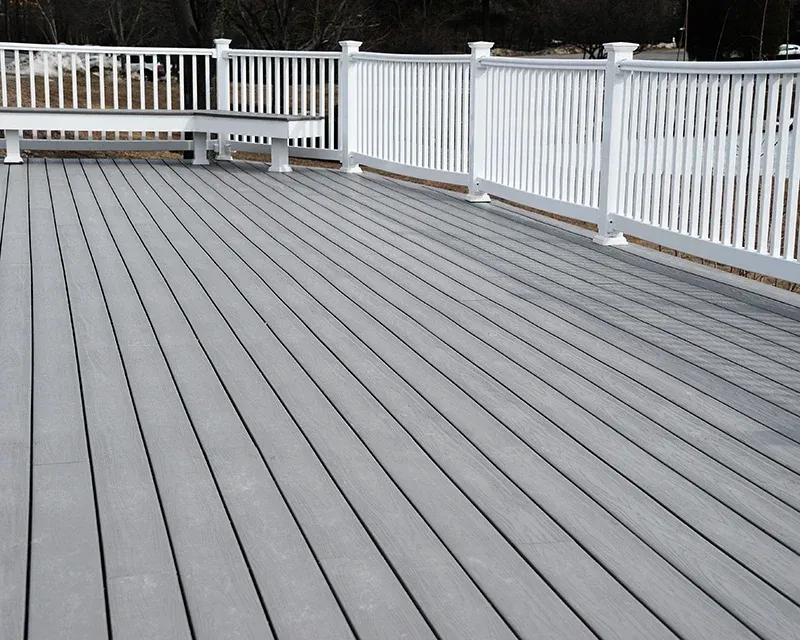 Gray composite deck with white railing and built-in bench.