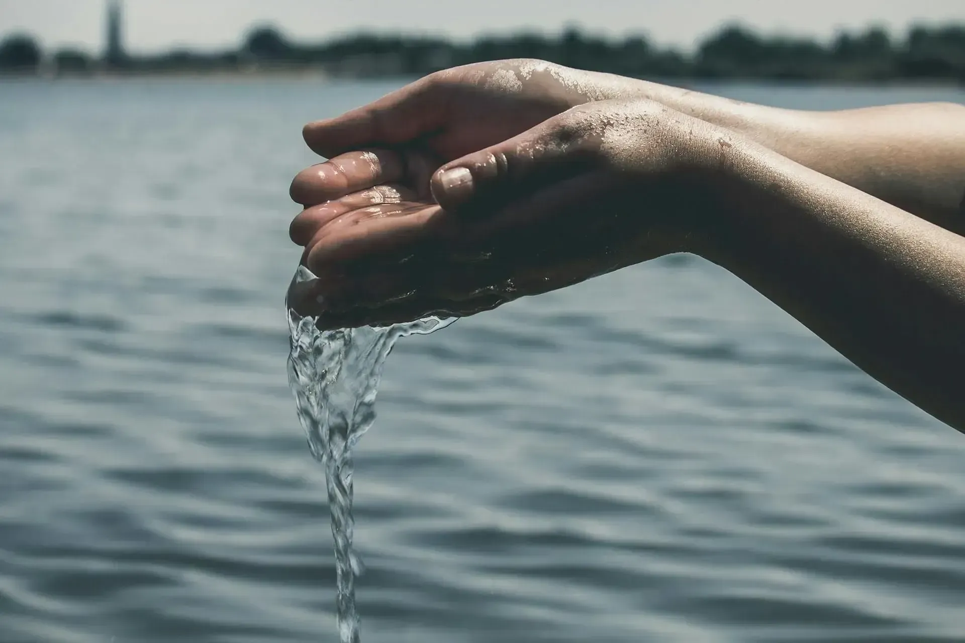 hands spilling water from hands