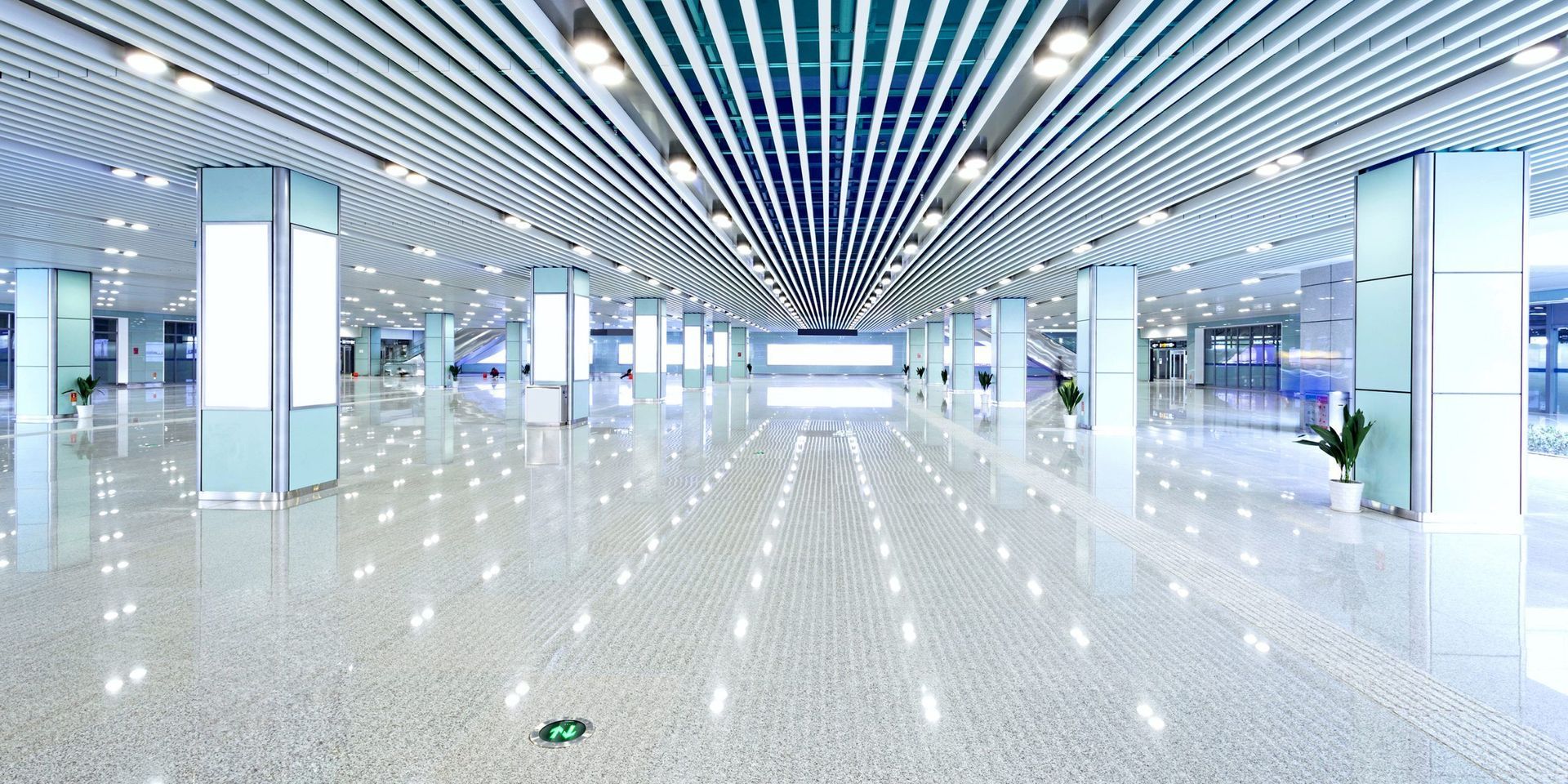 Large, bright interior space with reflective floor and many support columns.