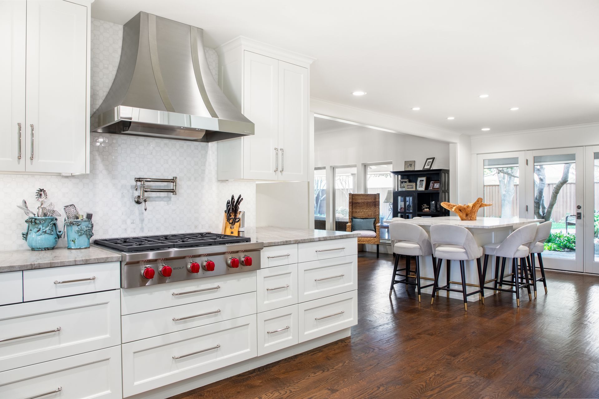 Spacious kitchen with blue island, stainless steel appliances, and white cabinets. Lakewood kitchen renovation.