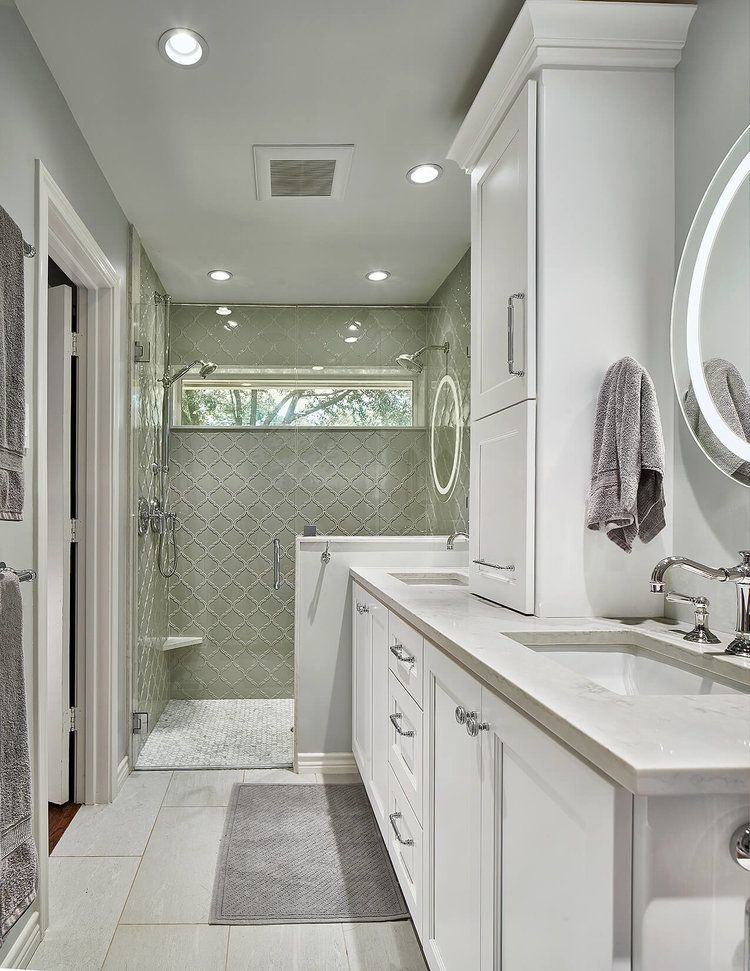 Modern bathroom with glass shower, white vanity, and light blue walls. Lake Highlands Bathroom renovation.