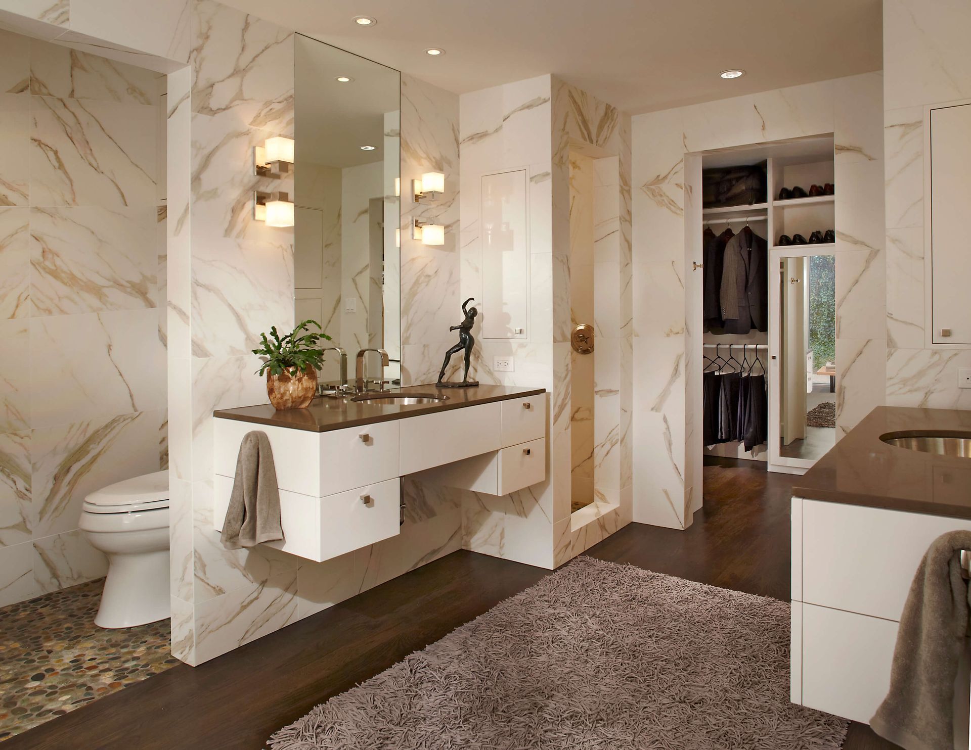Luxurious modern bathroom with marble walls, floating vanity, walk-in closet. Highland park bathroom renovation.