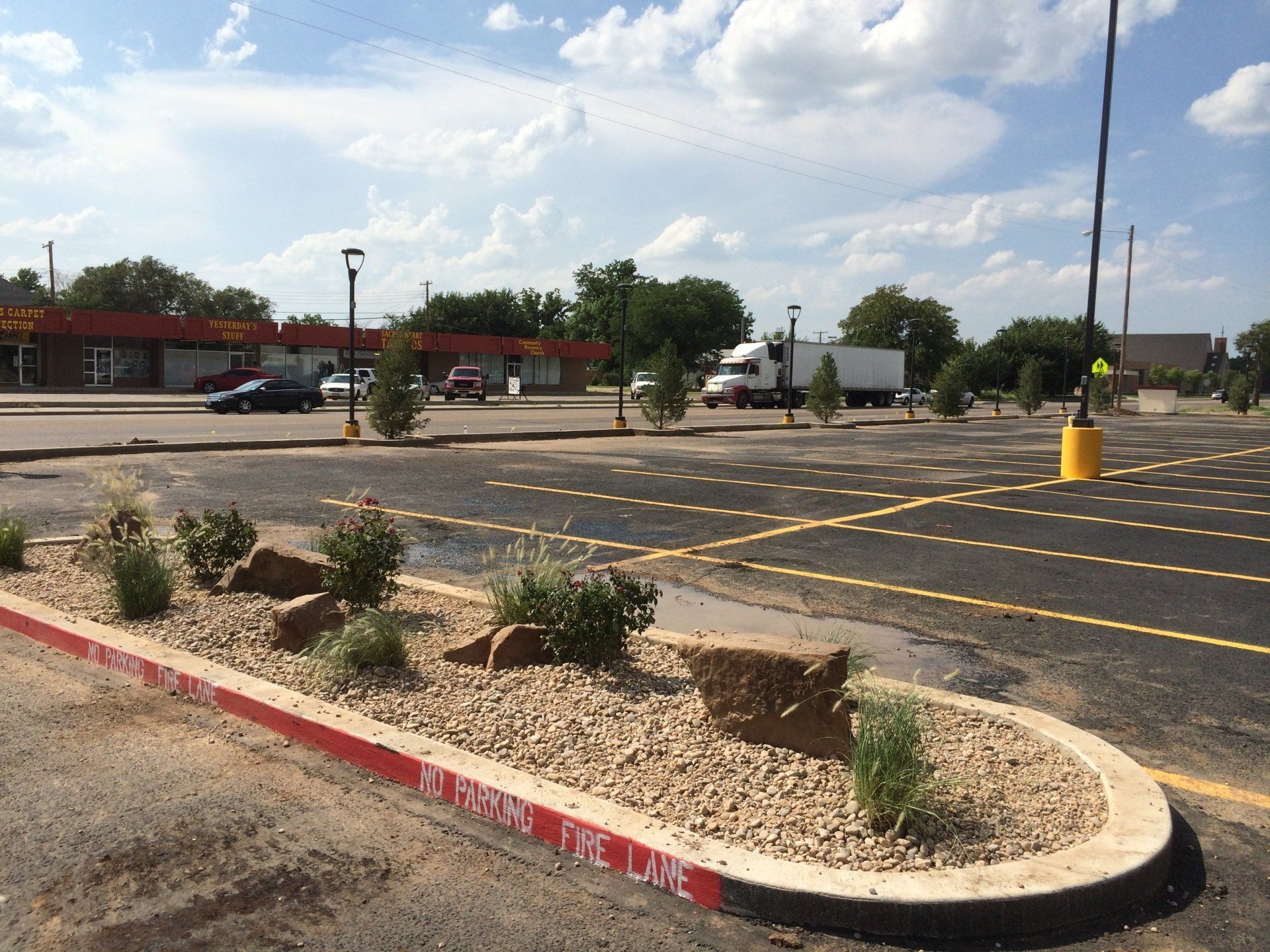 A parking lot with a planter in the middle and a sign that says stop the line