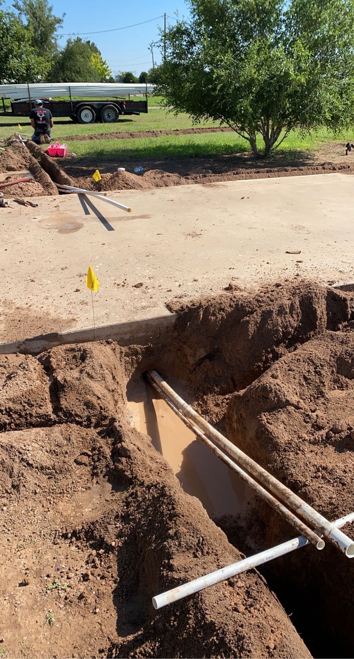 A pipe is being installed in a hole in the ground.