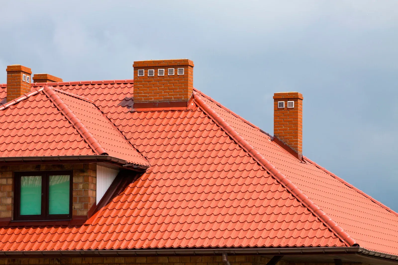 Orange tile roofs against a bright blue sky.