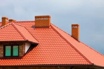Orange tile roofs against a bright blue sky.
