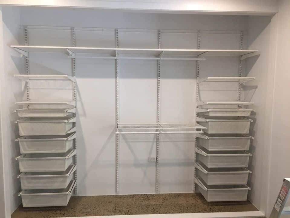 A closet with white shelving and clear storage bins stacked on the sides, empty. — Ezyshelf in Manunda, QLD 