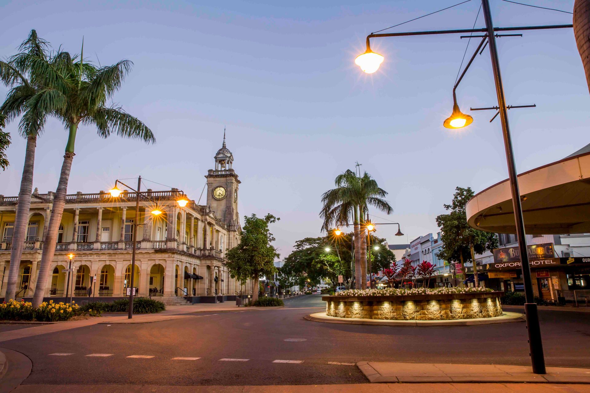 Town Square With Ornate Building and Clock Tower, Palm Trees, and Streetlights — Ezyshelf in Mackay, QLD  