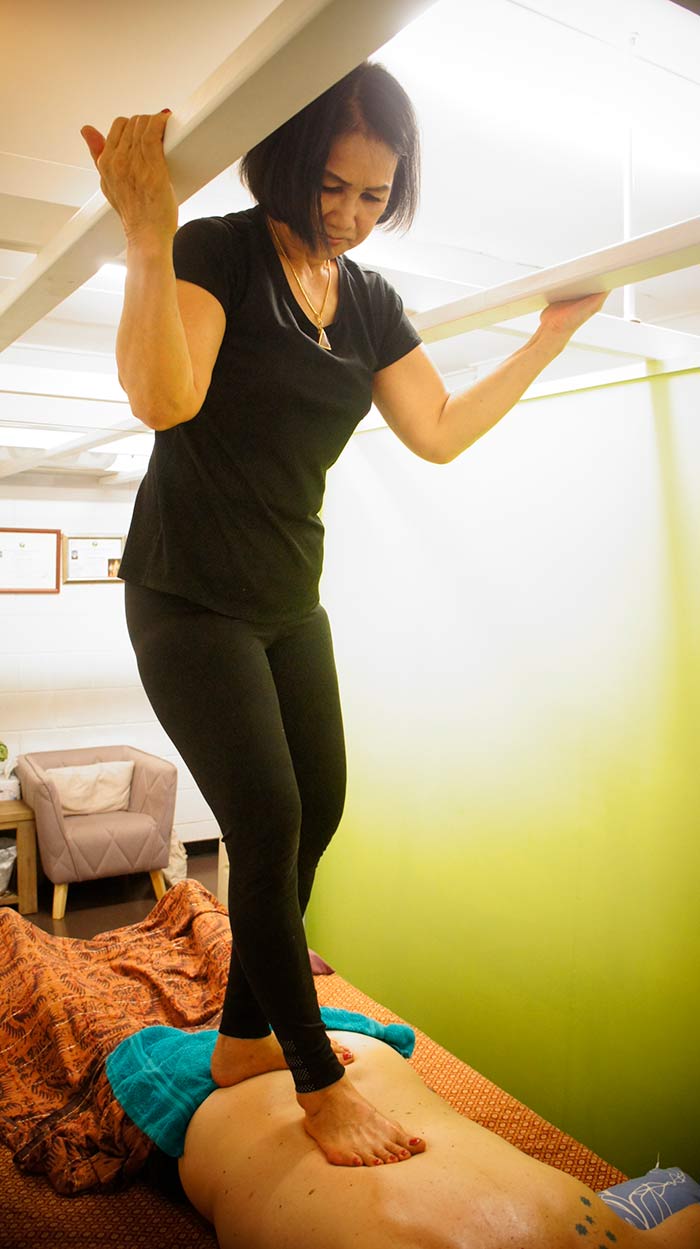 woman standing on man's back