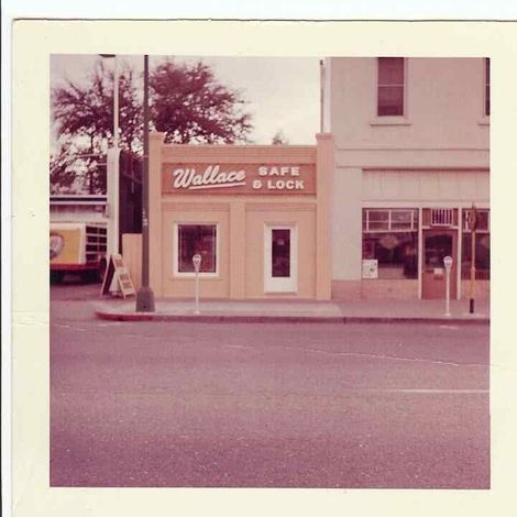 Exterior of Wallace Safe & Lock cafe on a street, tan building with sign, street level view.