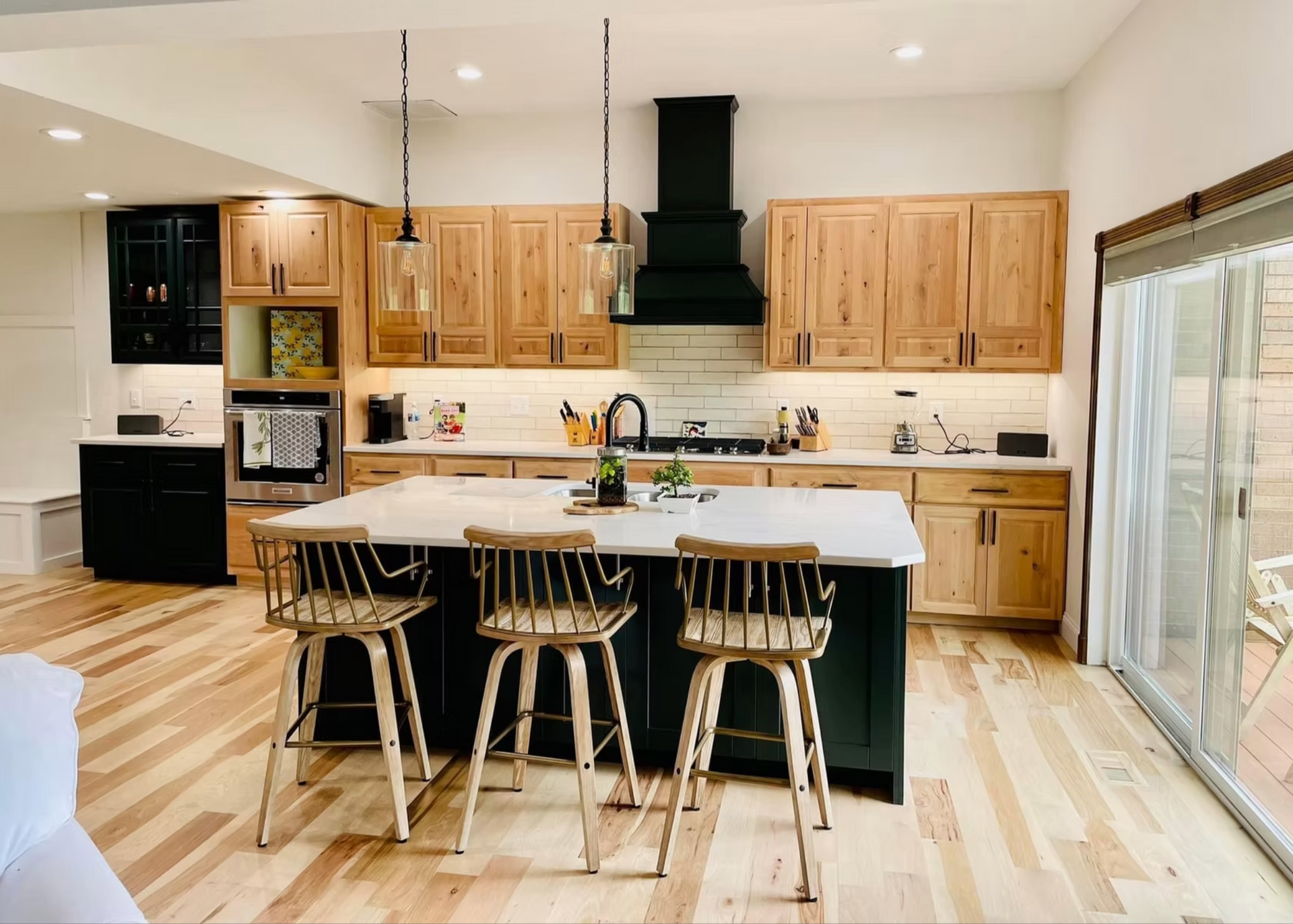 A kitchen with white cabinets and a large island in the middle