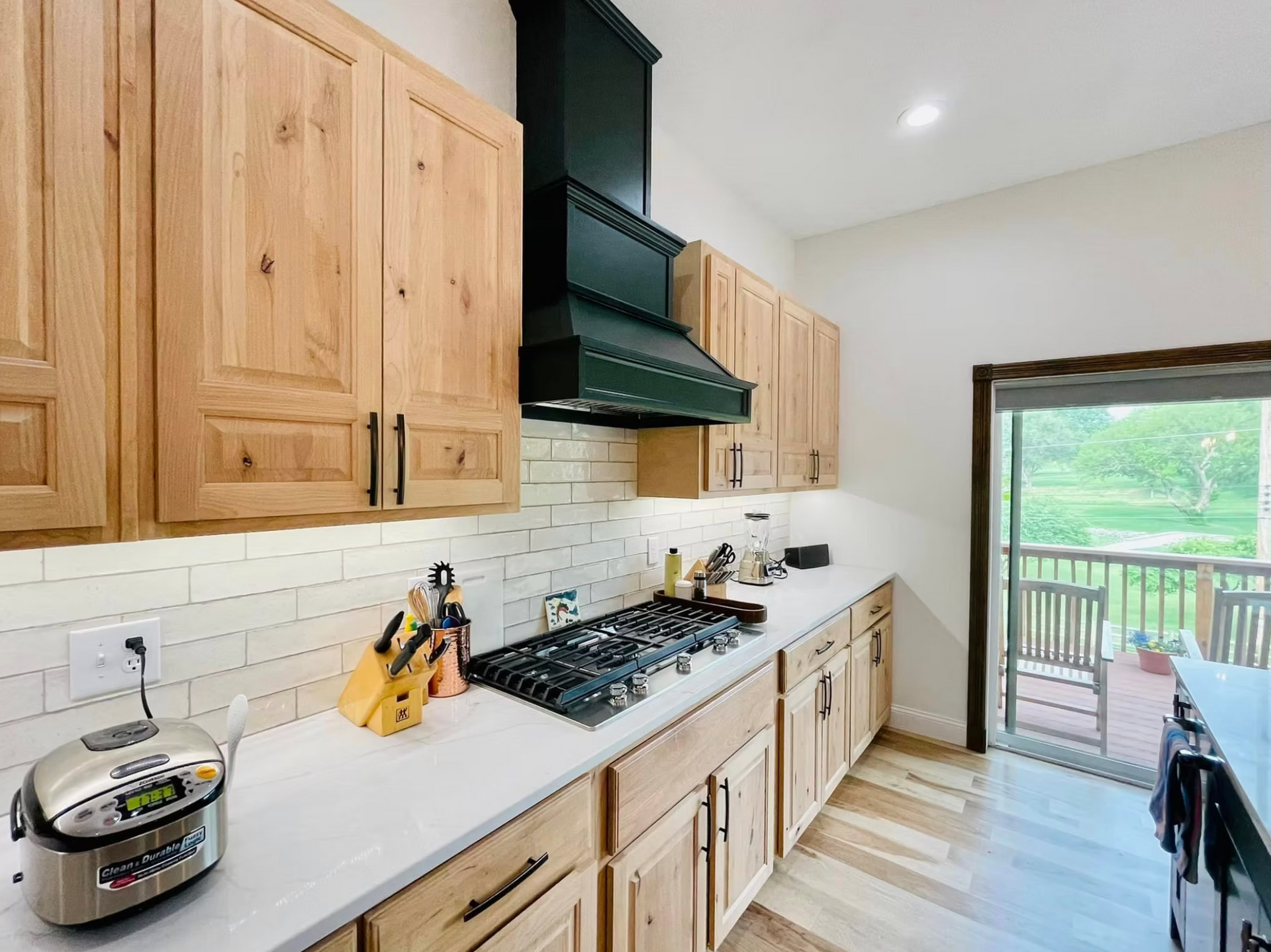 A large white house with three garage doors
