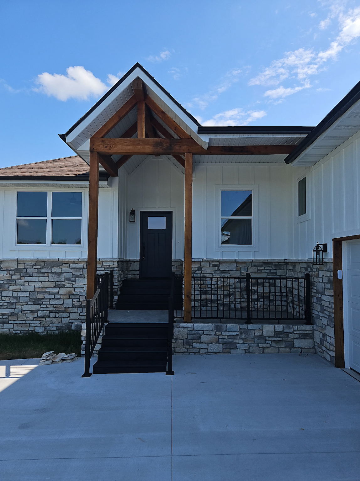 A large house with a blue roof and a blue door is lit up at night.