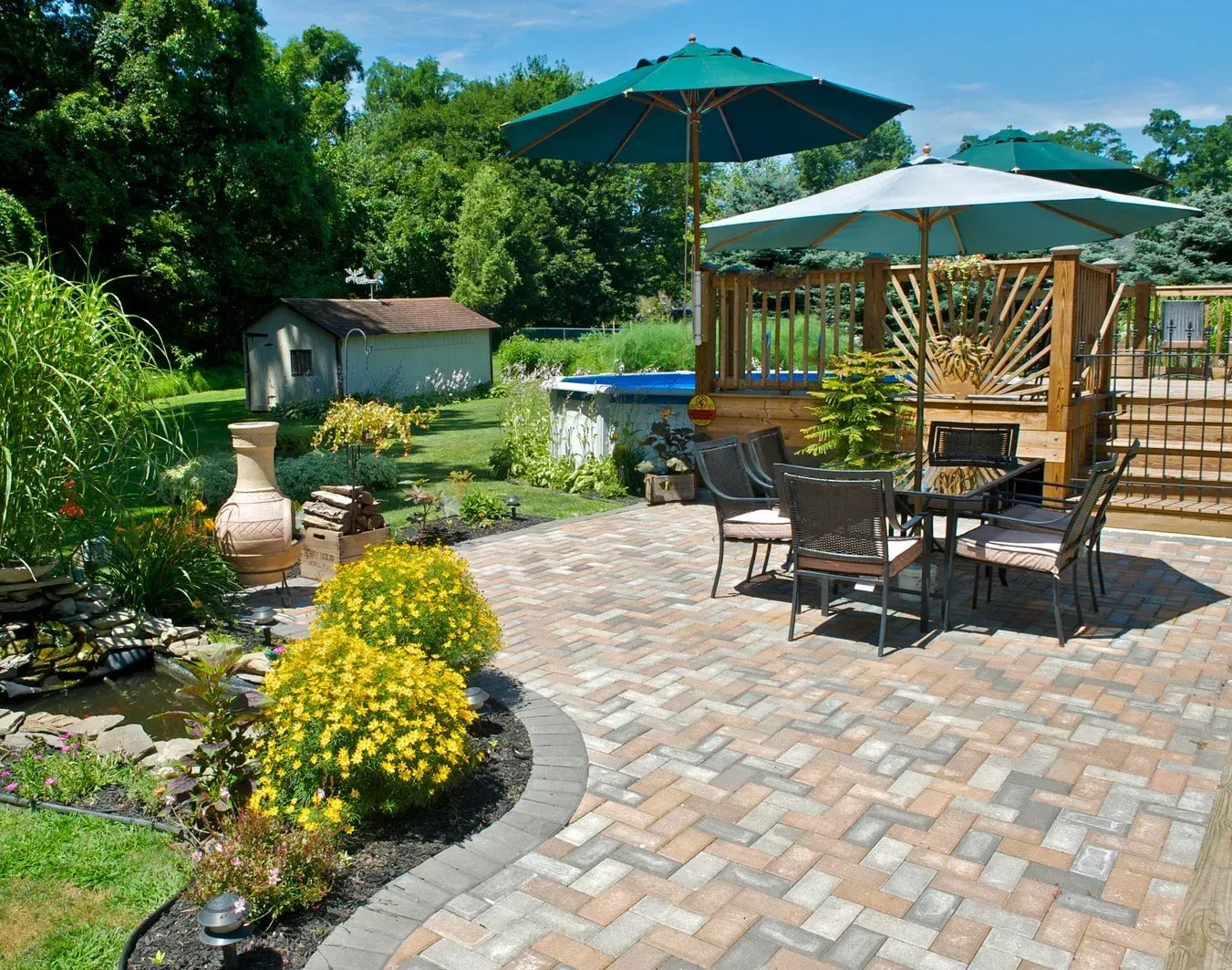 A patio with a table and chairs and umbrellas