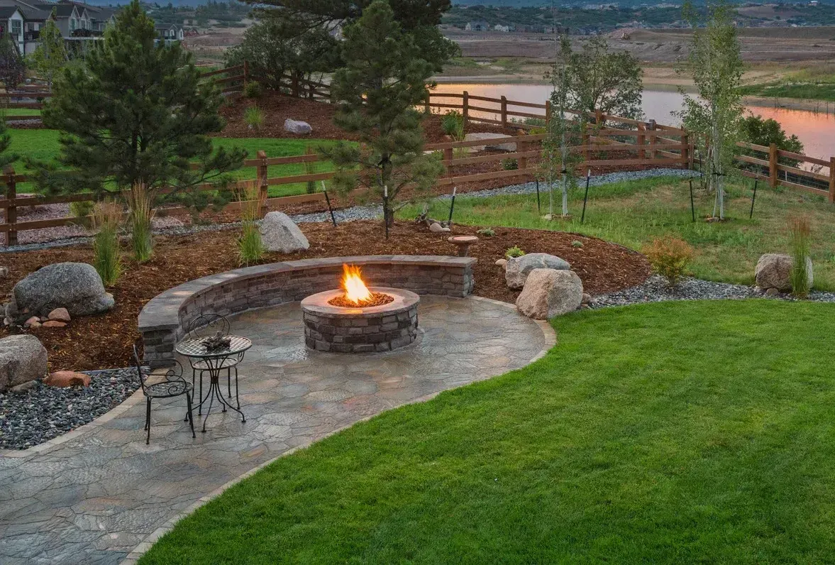 There is a fire pit in the middle of the backyard.