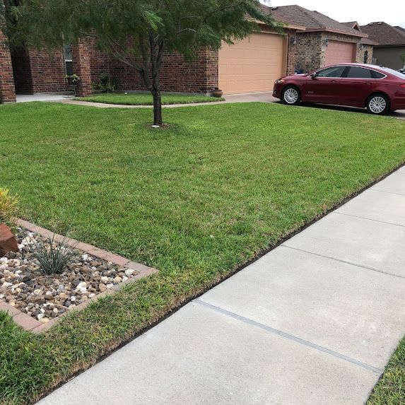A red car is parked in front of a house