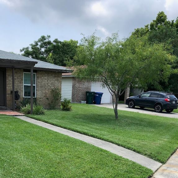 A house with a car parked in front of it.