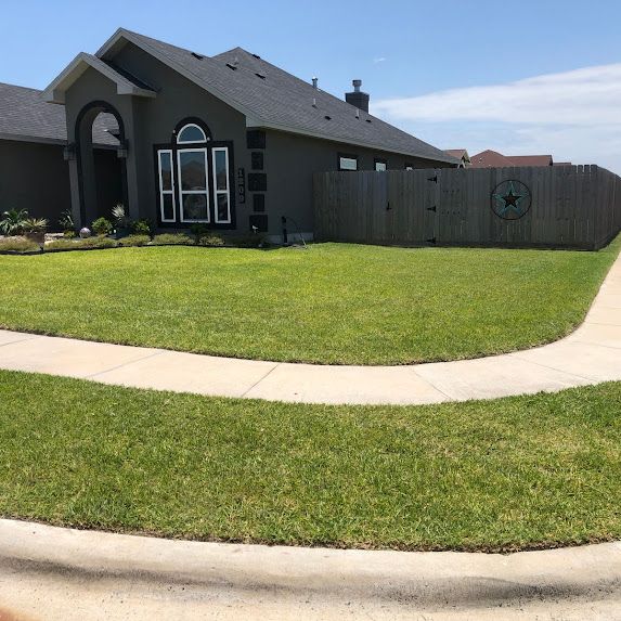 A house with a fence and a walkway in front of it