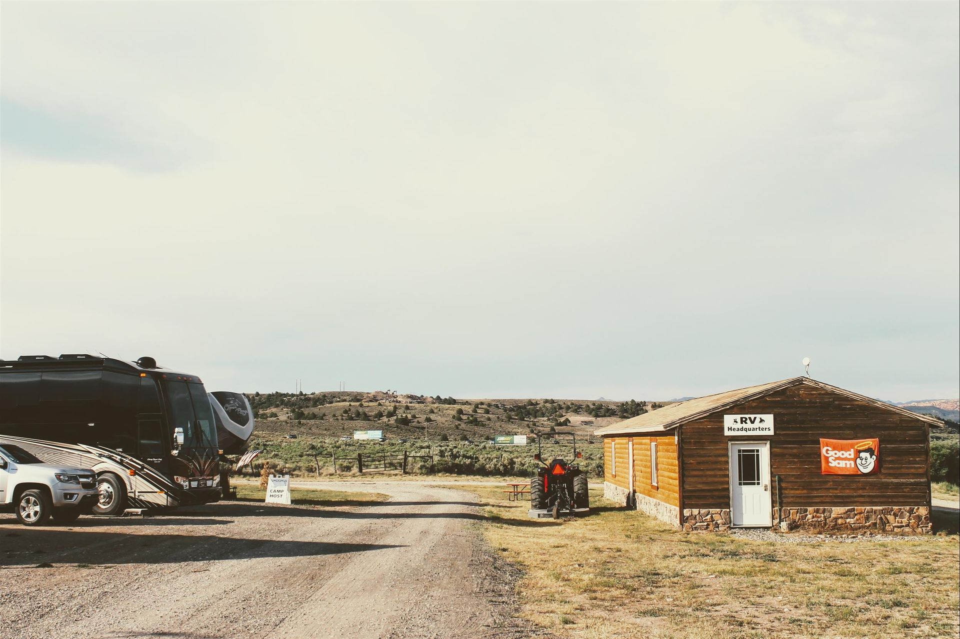 A motorcycle is parked in front of a small wooden building.