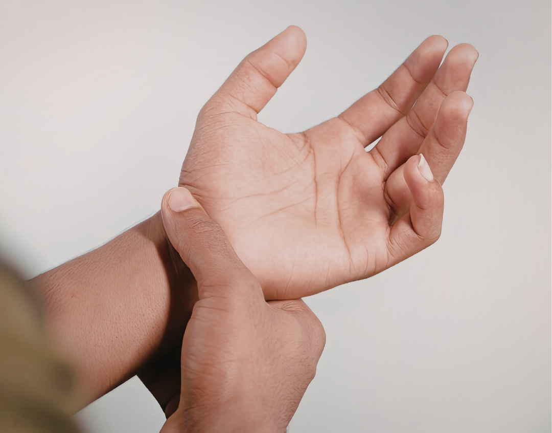 person holding wrist in pain