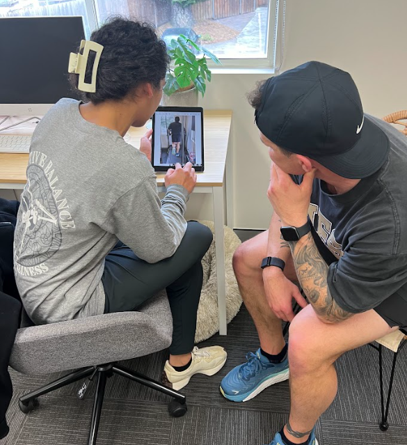 Physiotherapist going over running analysis at Active Balance Physio & Wellness