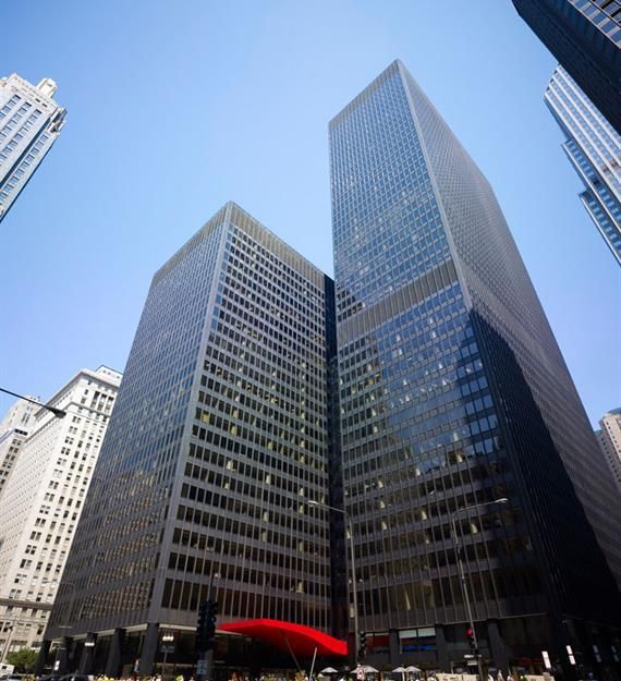 Looking up at a very tall building with a red awning