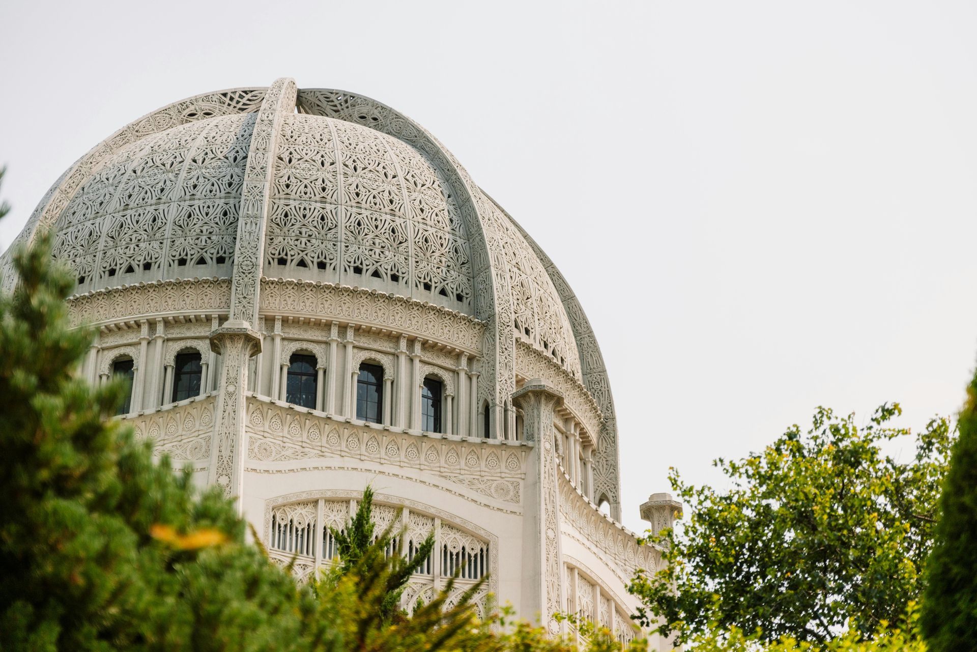 A large building with a dome on top of it is surrounded by trees.