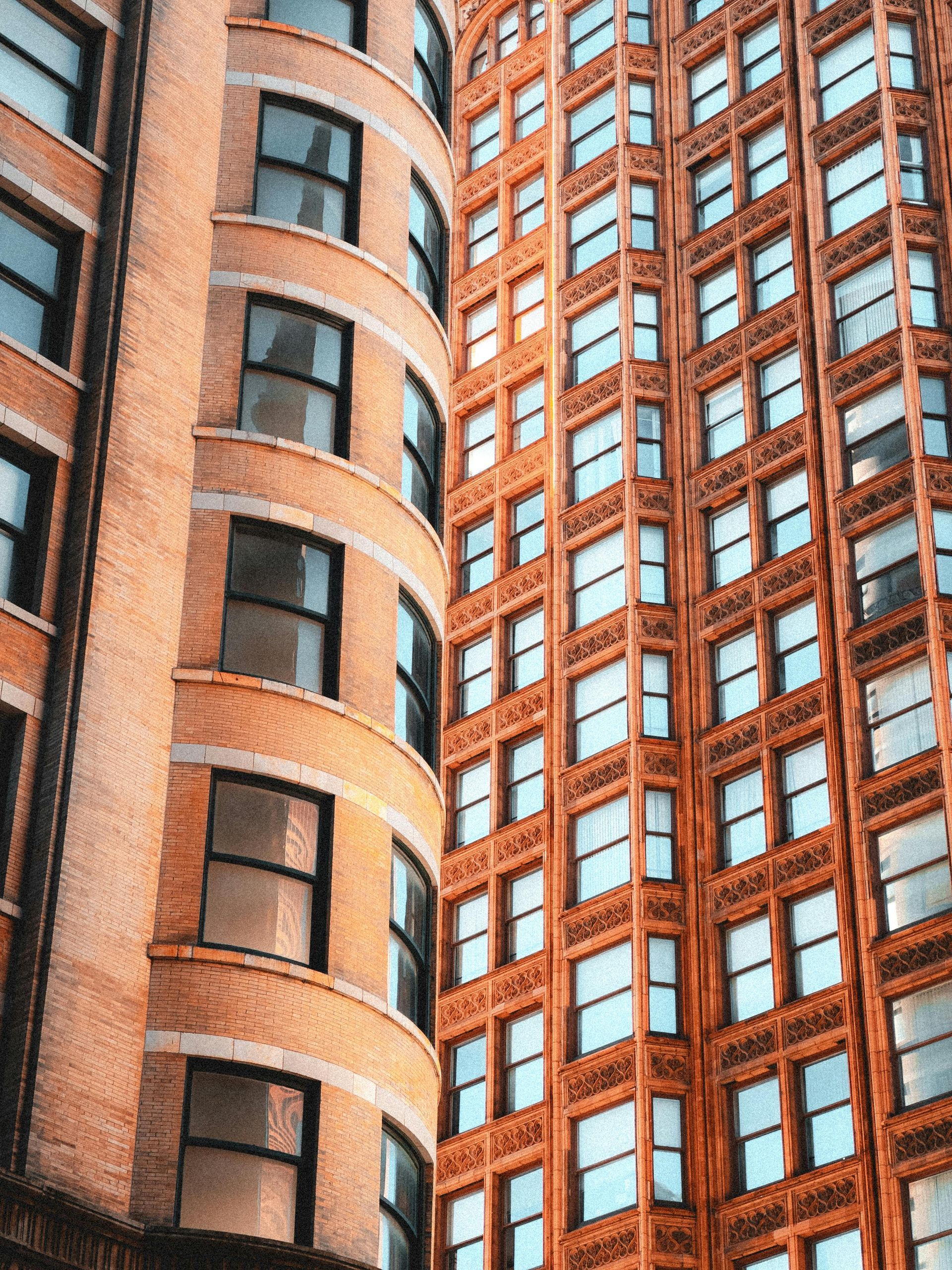 A tall brick building with a lot of windows and a lot of windows.
