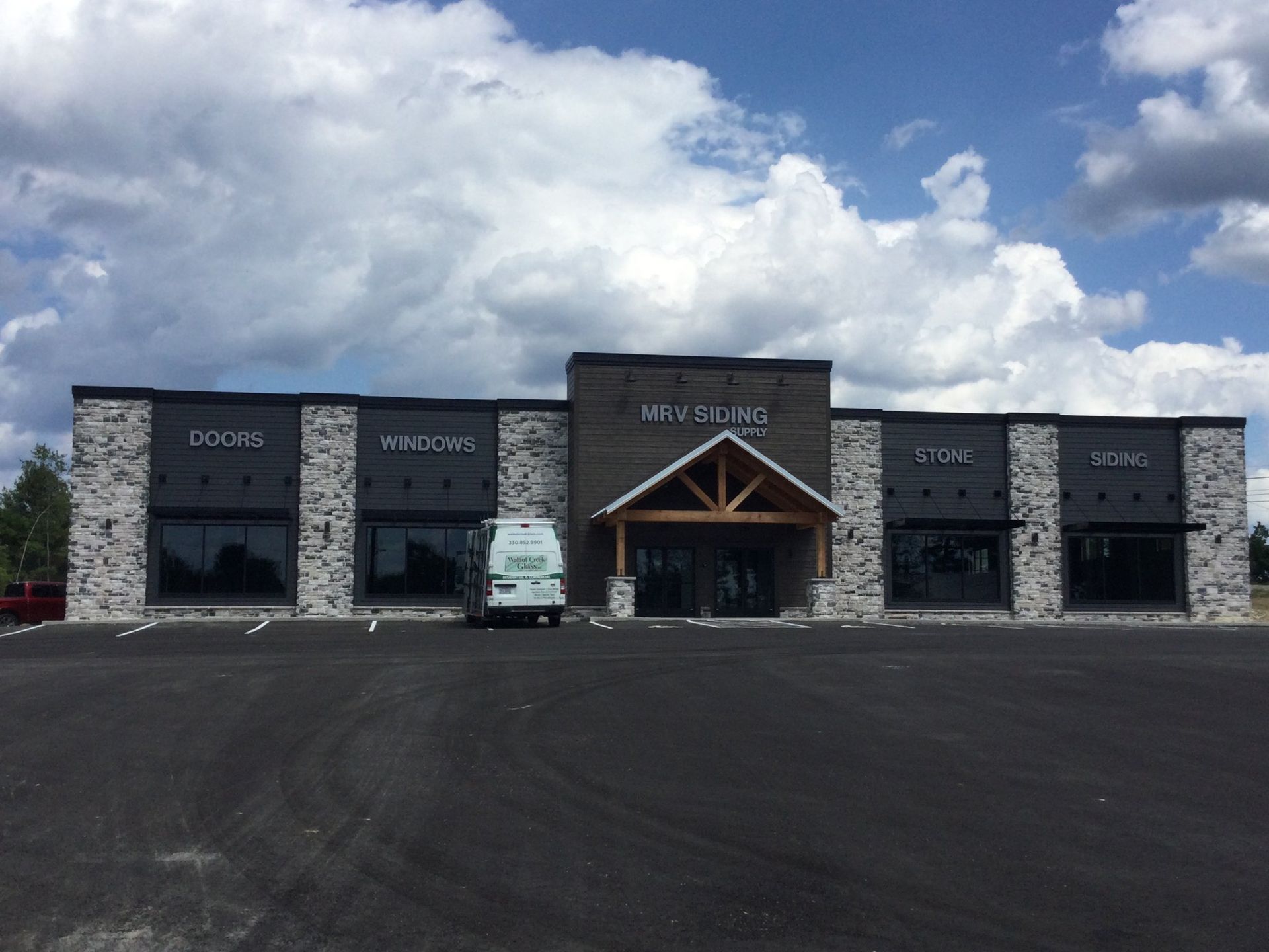 A large building with a van parked in front of it