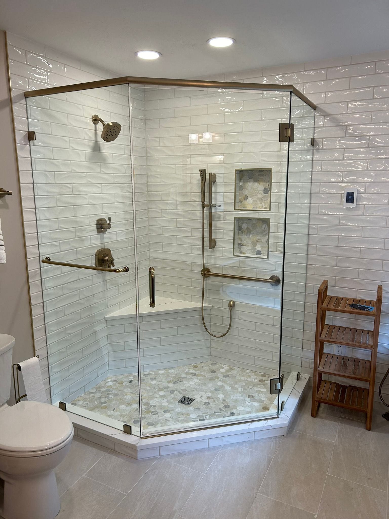 A bathroom with a walk in shower and a toilet.