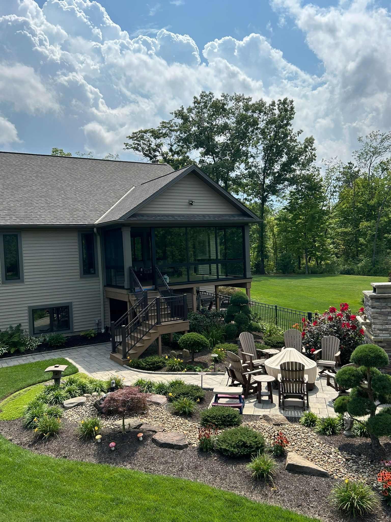 A house with a large lawn and a patio in front of it.