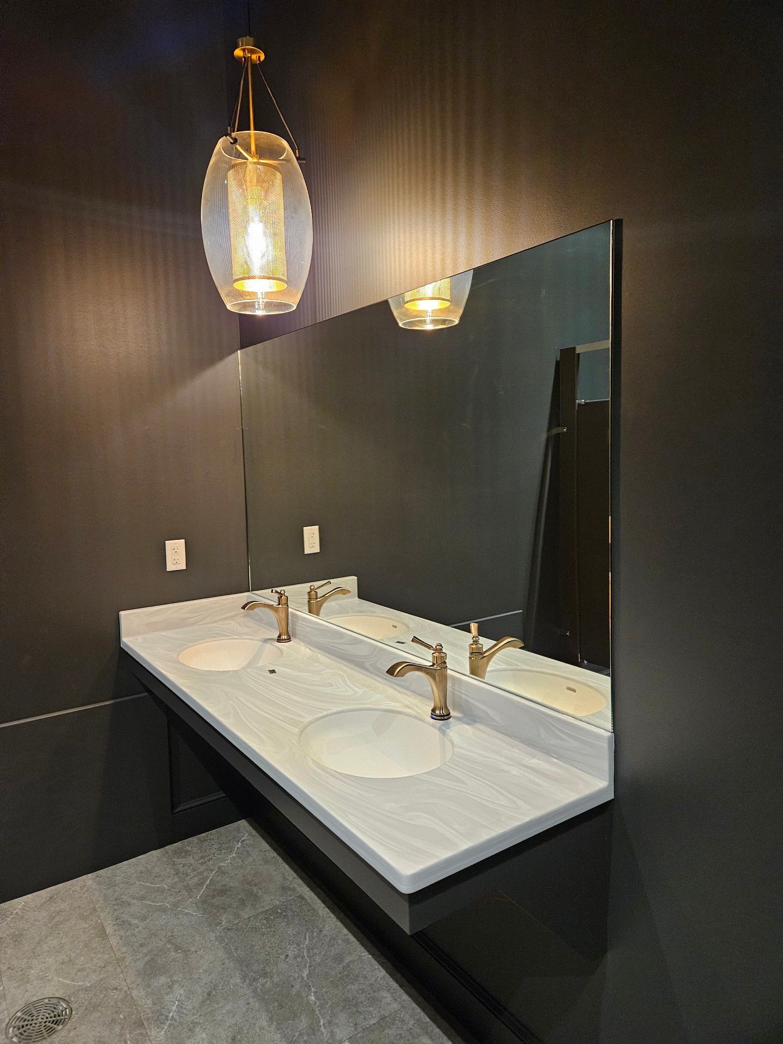 A bathroom with two sinks and a large mirror.