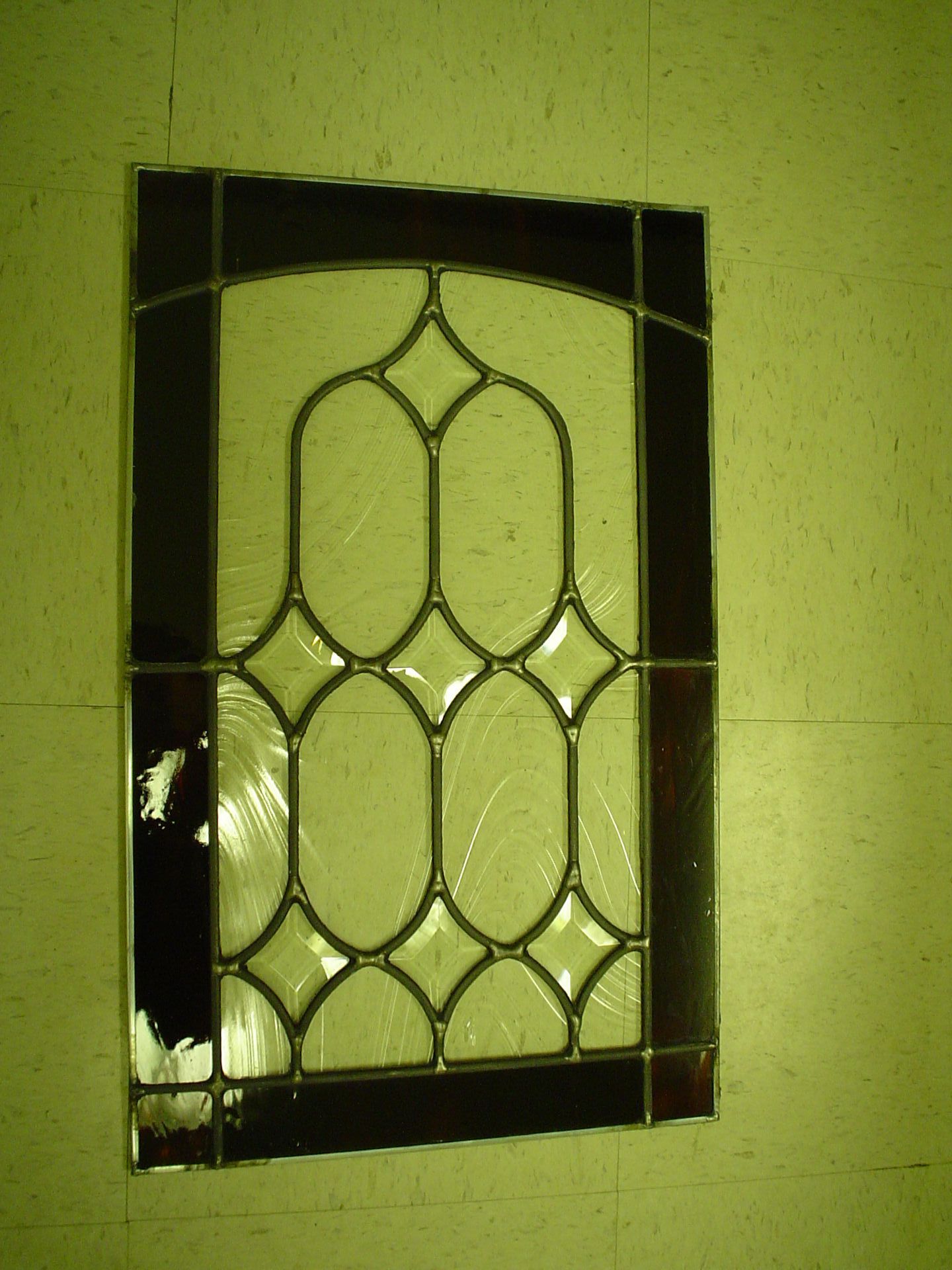 A stained glass window is hanging on a wall