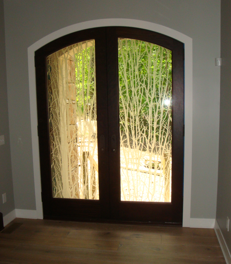 A door with a reflection of trees in it