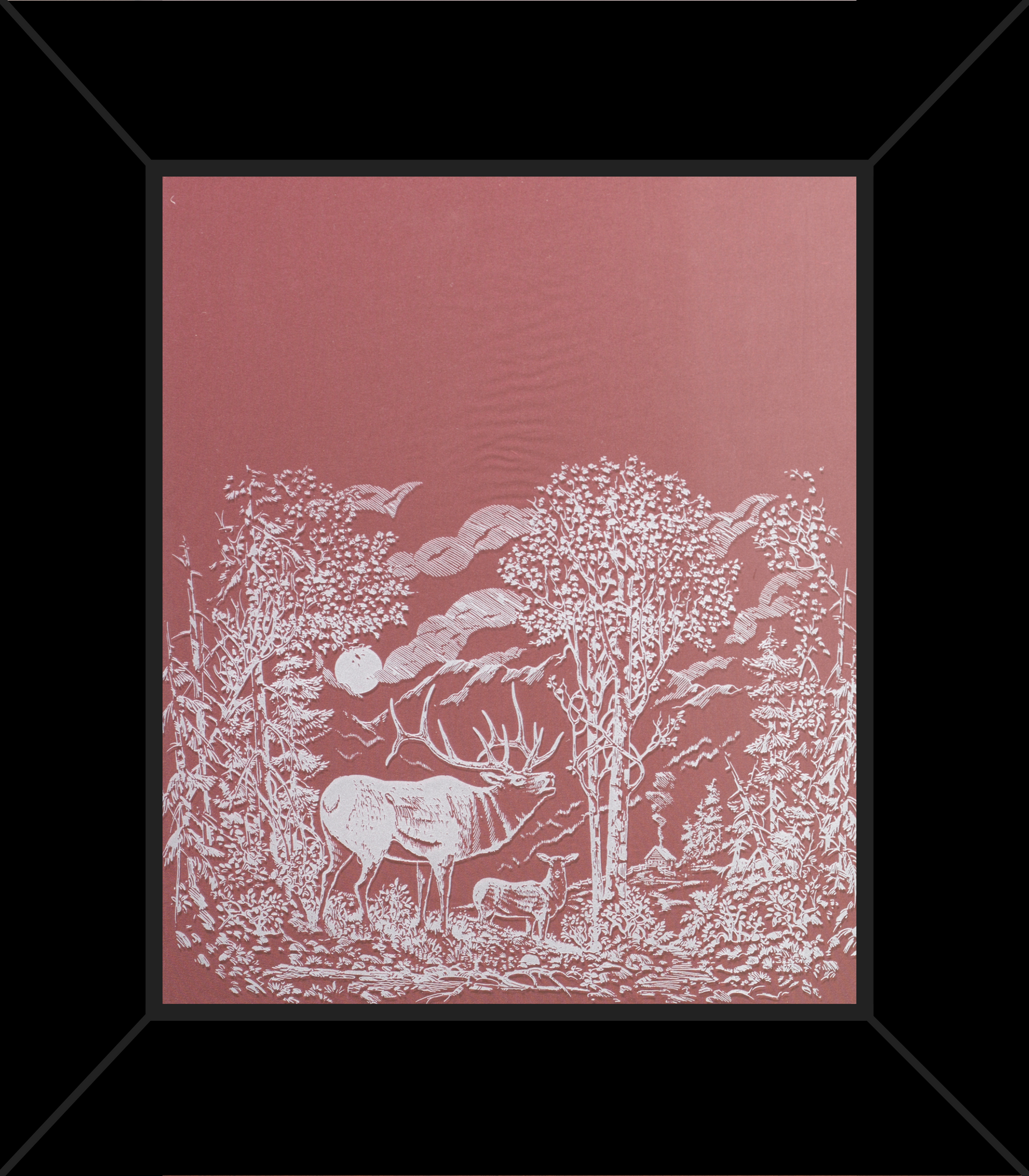 A framed picture of a deer in a forest
