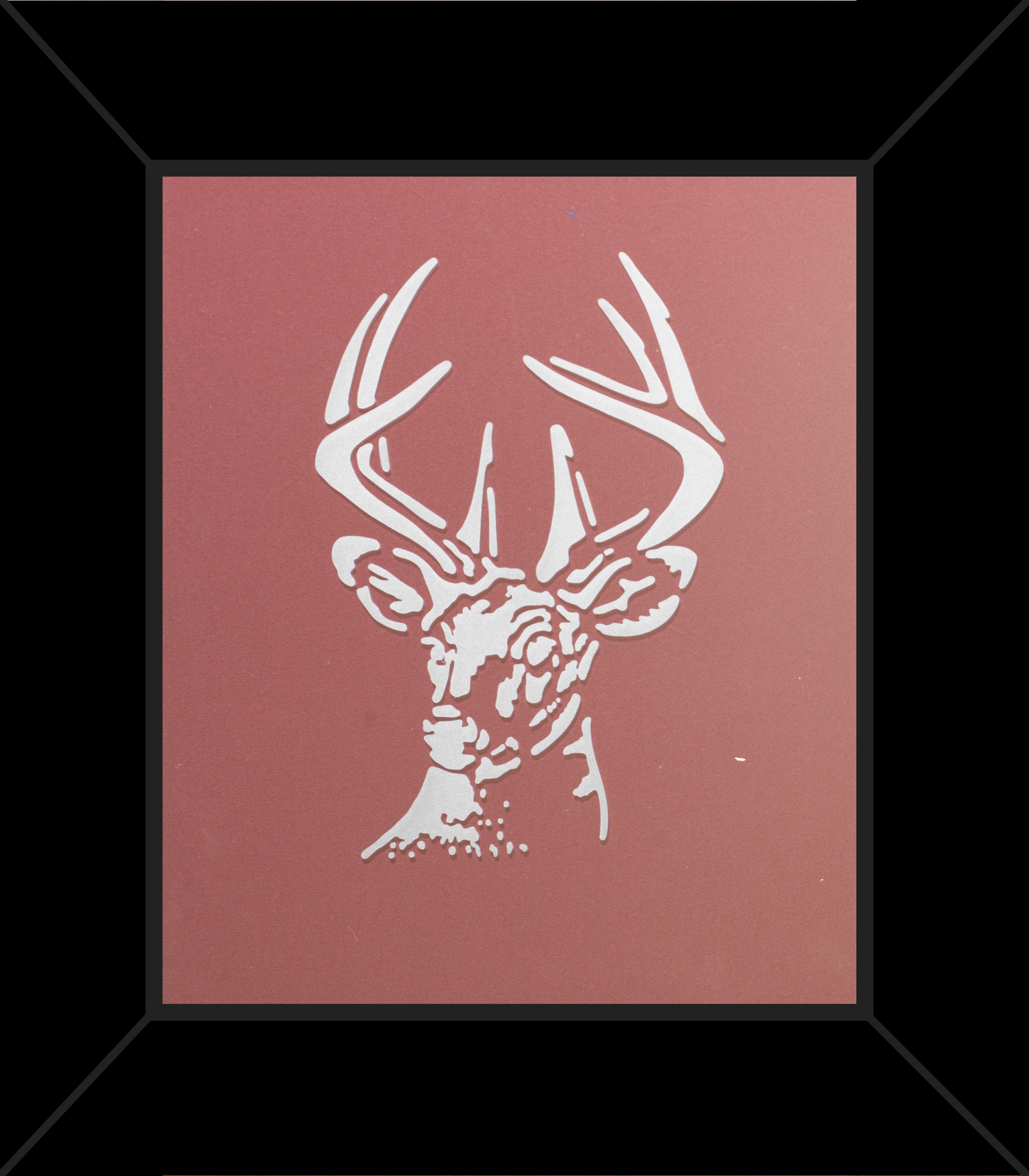 A picture of a deer 's head in a black frame