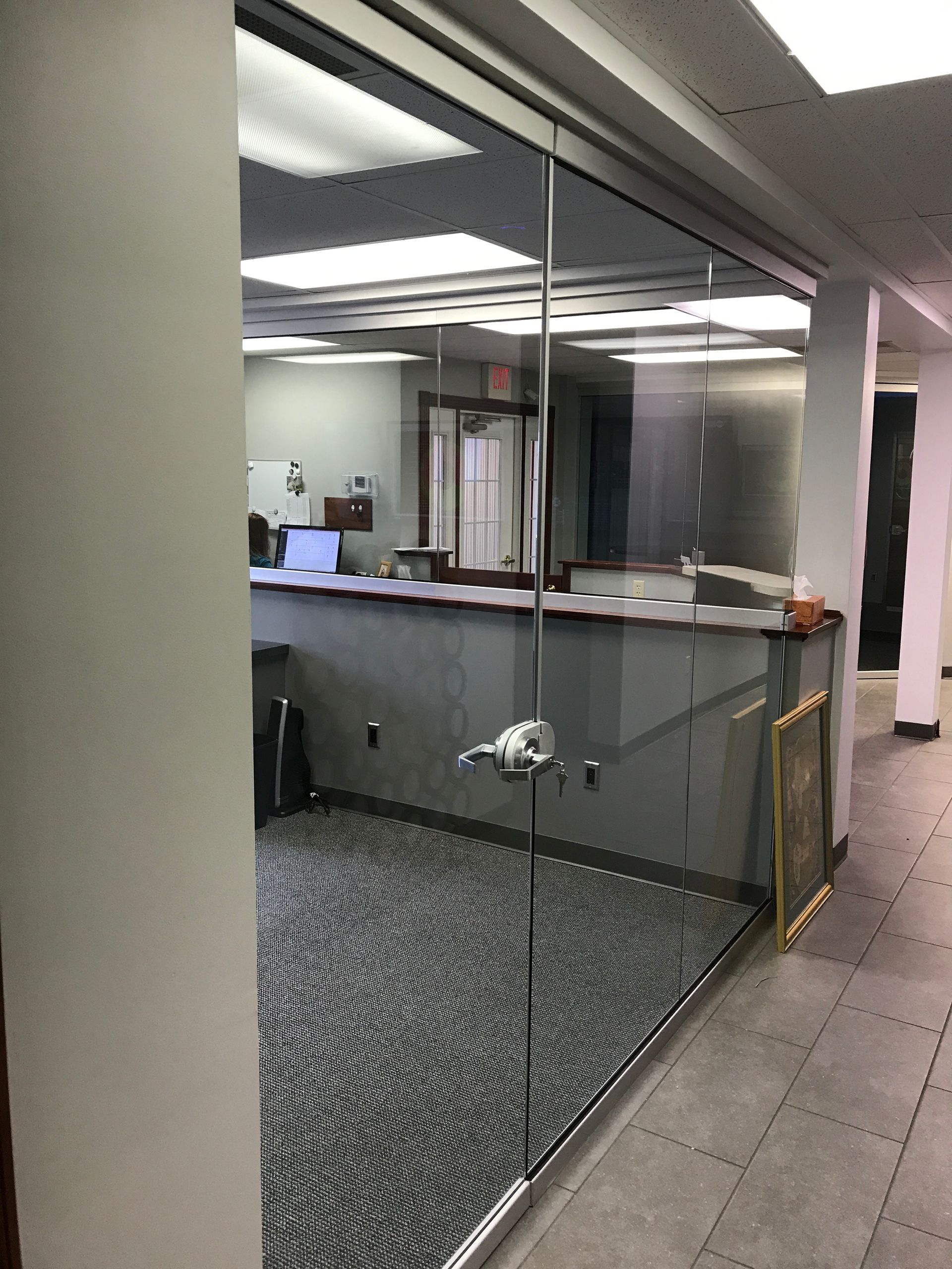 A room with a glass wall and a counter