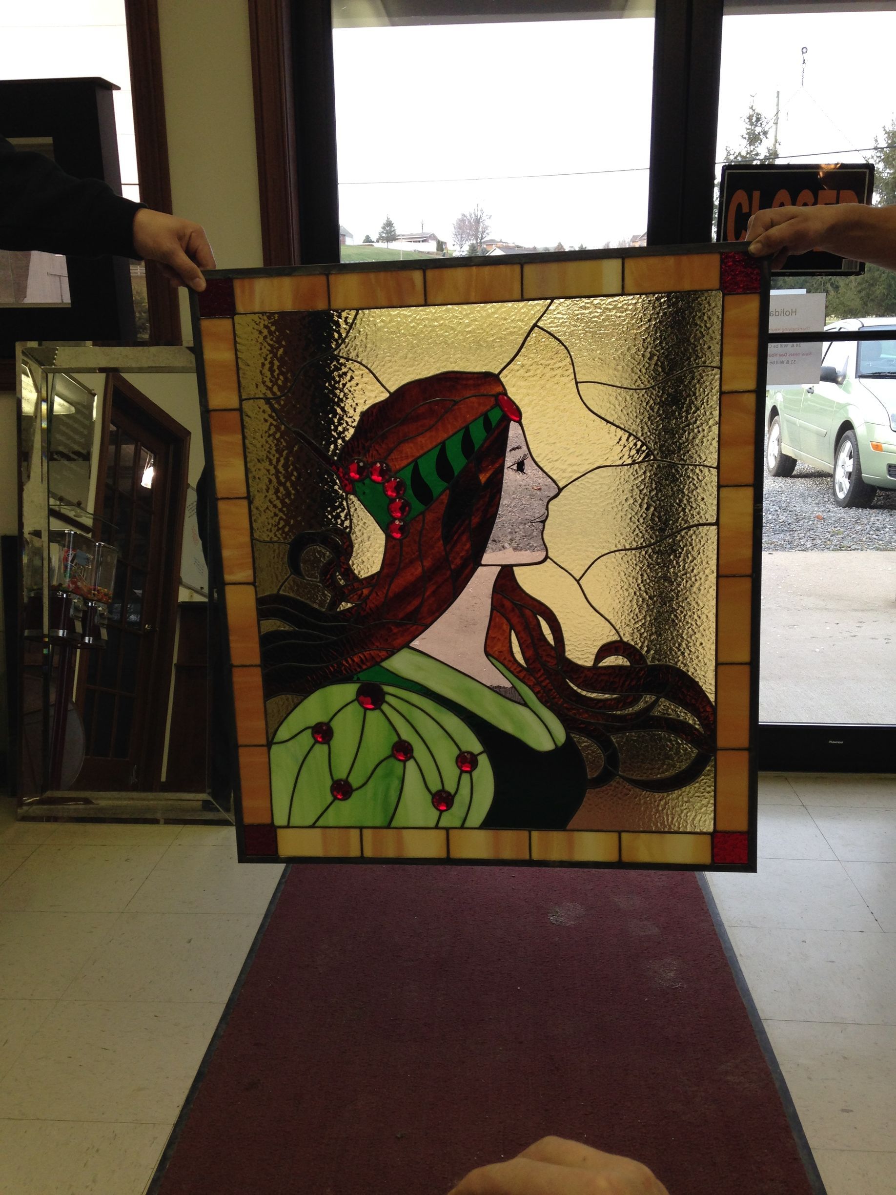 A stained glass painting of a woman with long hair