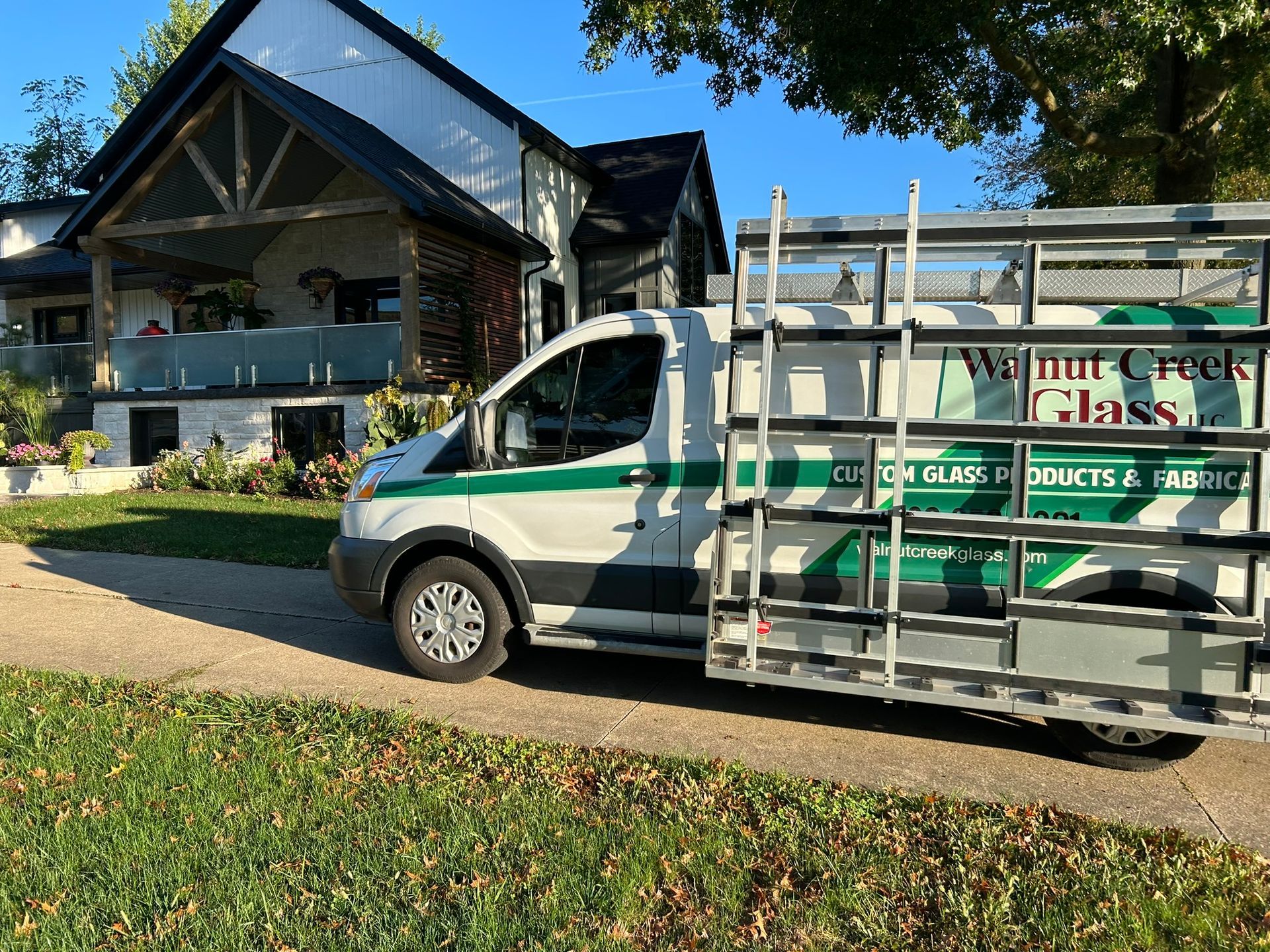 A walnut creek glass van is parked in front of a house