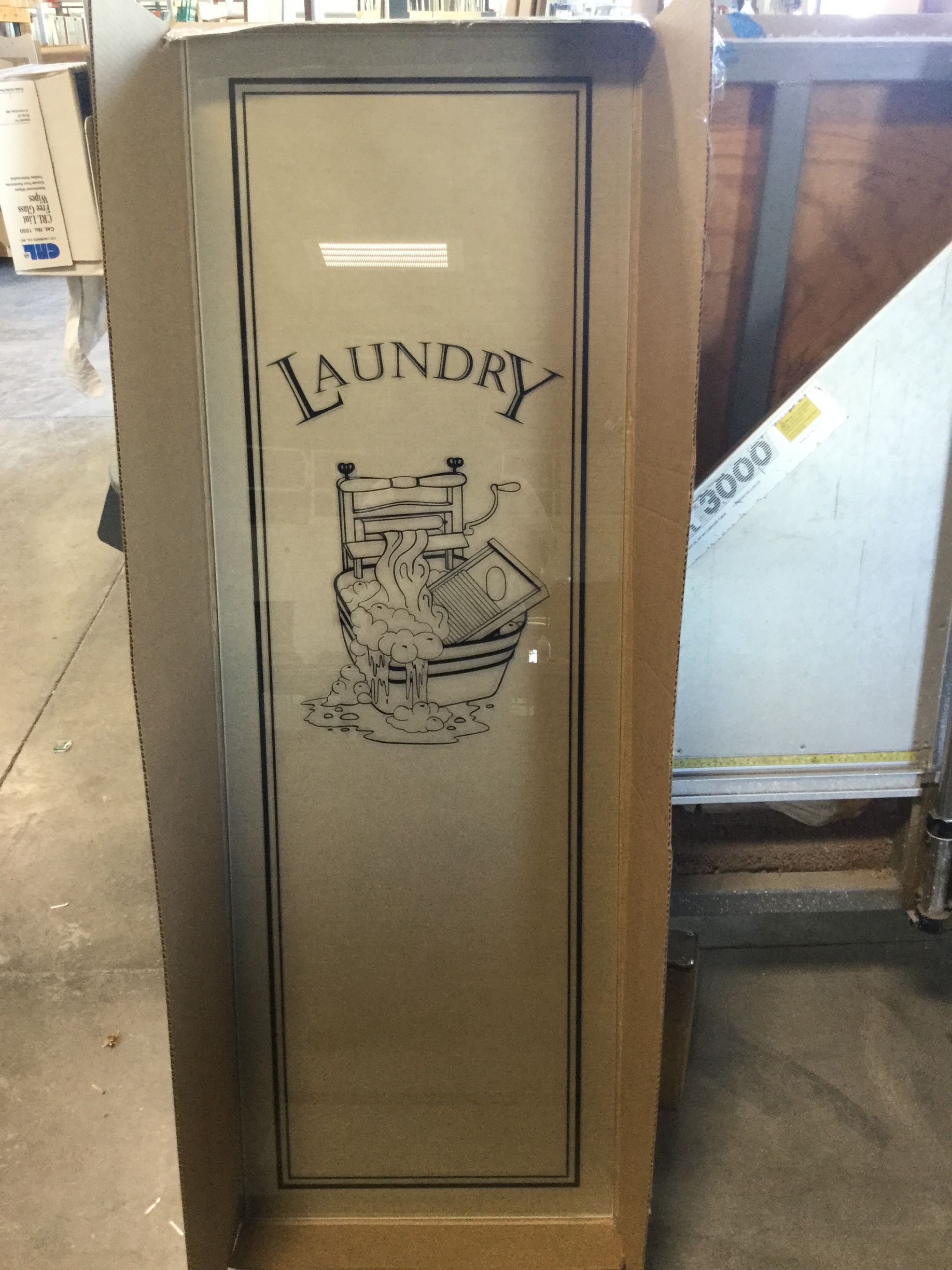 A laundry door is sitting in a cardboard box