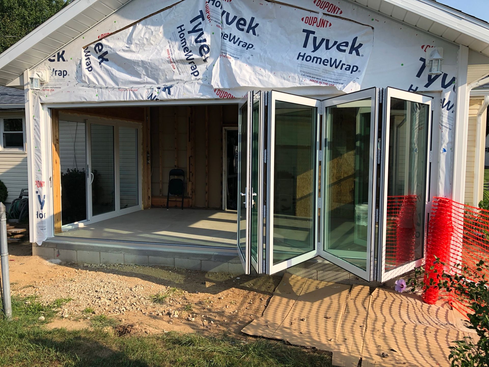A house with a lot of windows and doors is being built.